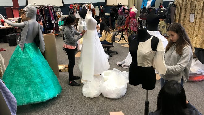 Dresses and gowns made from various reclaimed materials are assembled at the Paterson Museum.